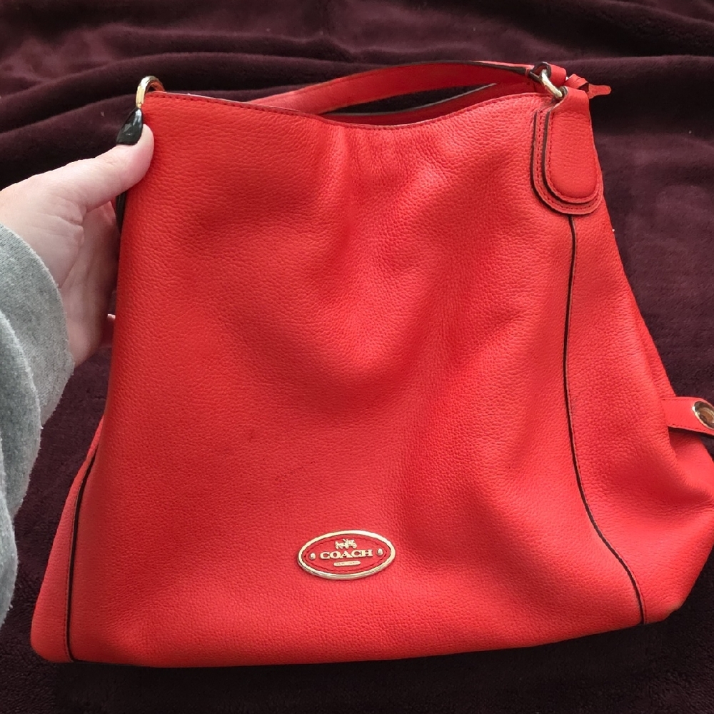 Coach Edie shoulder bag in Orange pebbled leather.
